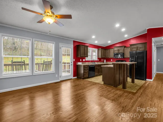 a view of an empty room with a window and cabinet