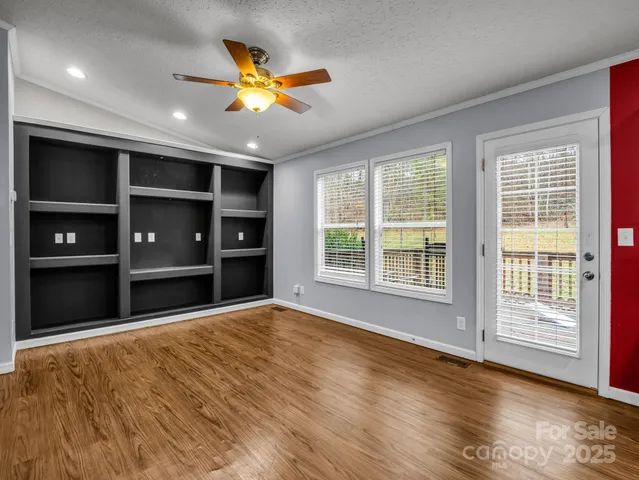 a kitchen with stainless steel appliances kitchen island granite countertop a refrigerator and a sink