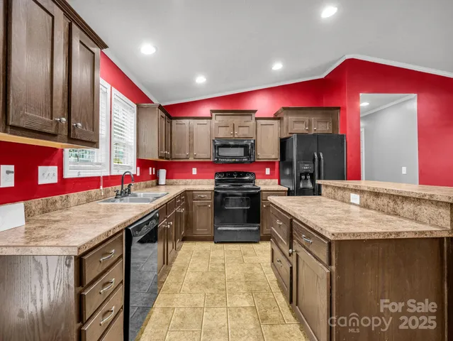 a kitchen with a stove a kitchen island a dining table and chairs