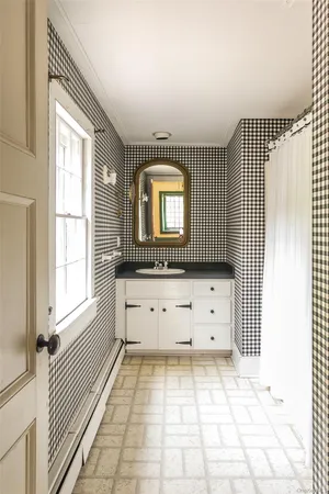wooden floor with white walls and window