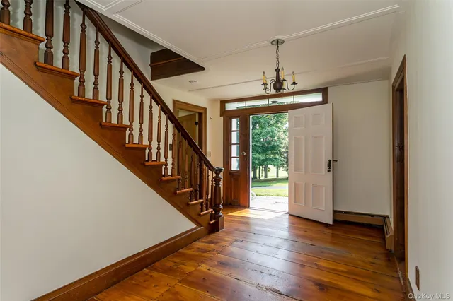 a view of an entryway with wooden floor