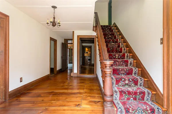 a view of an entryway with wooden floor