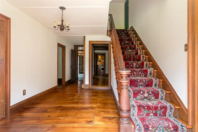 a view of an entryway with wooden floor