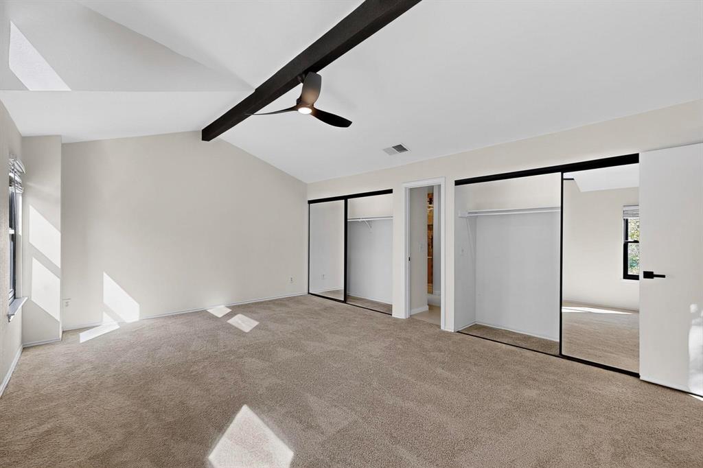 5009 Milam Street Dallas, TX 75206 - Photo 16 of 35 Unfurnished bedroom with two closets, light carpet, beamed ceiling, and ceiling fan