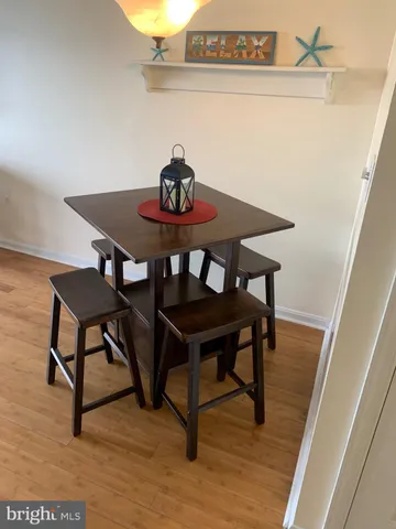 a view of a table and chairs in wooden floor