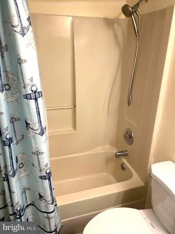 a bathroom with a bathtub and shower