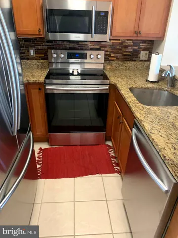 a kitchen with a stove a sink and a microwave