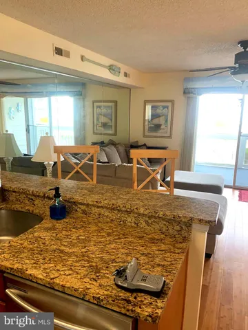 a view of a living room and kitchen