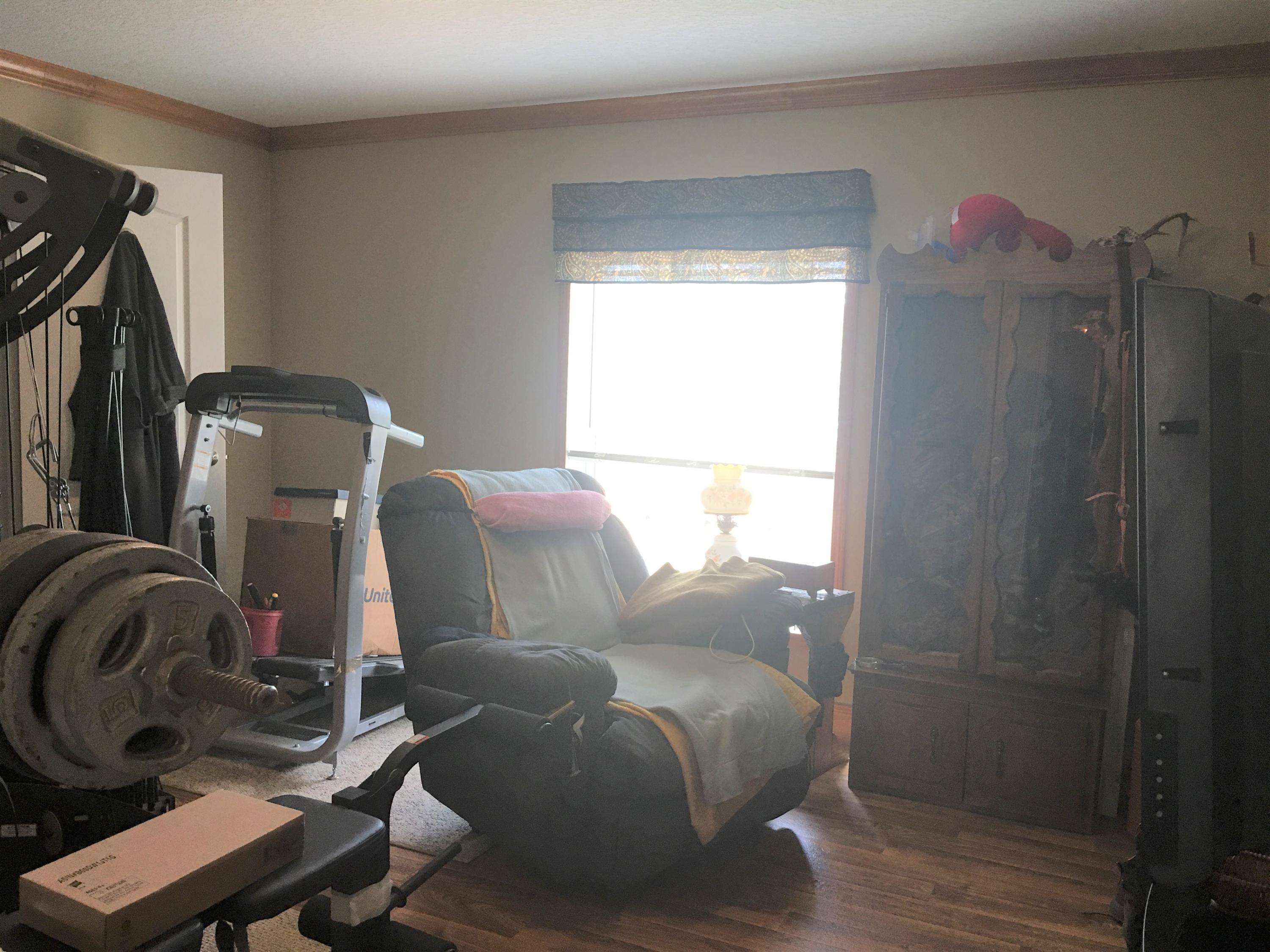 5470 Steele Road Baker, FL 32531 - Photo 13 of 22 a room with a bed and a mirror