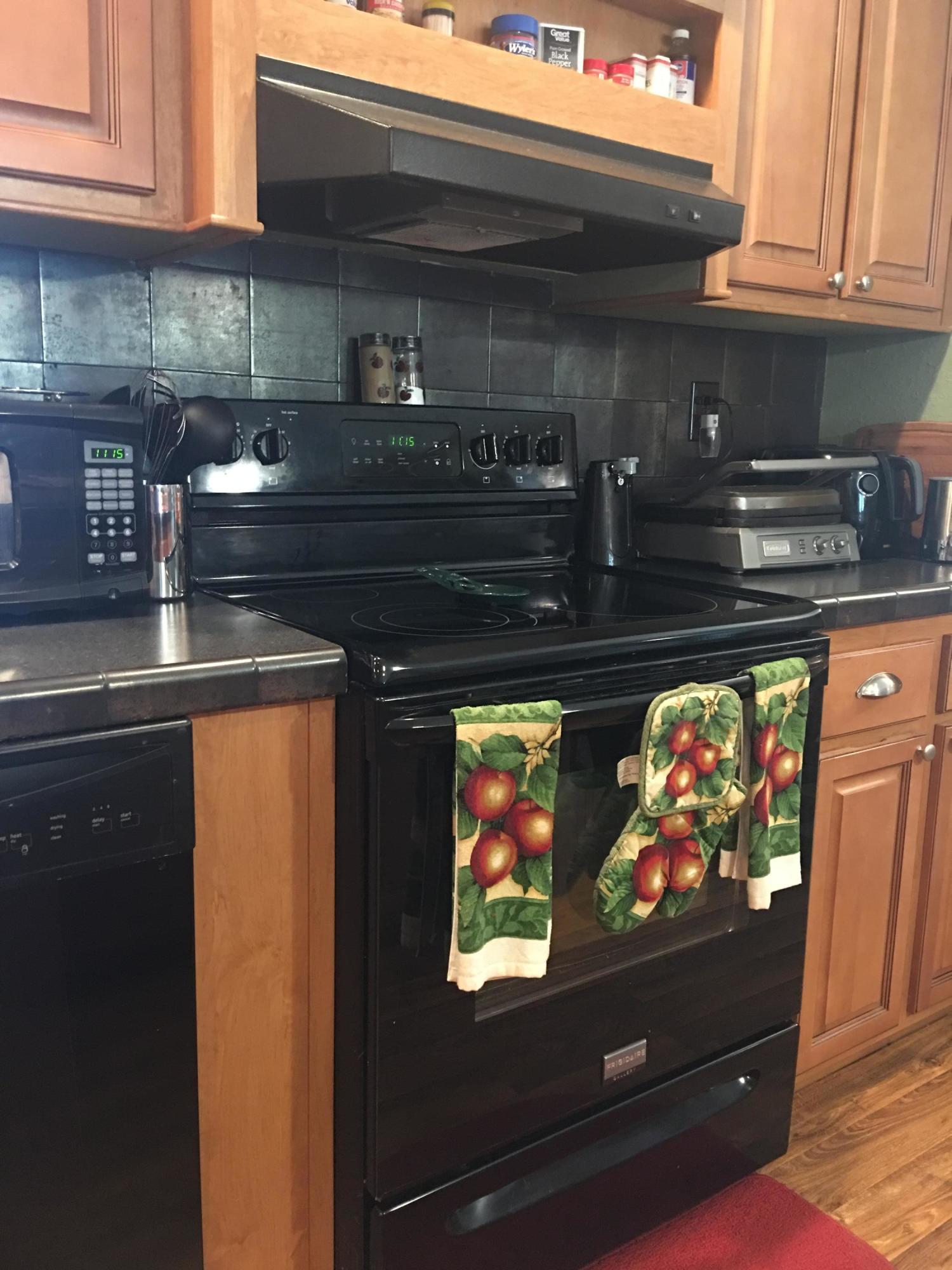 5470 Steele Road Baker, FL 32531 - Photo 7 of 22 a stove top oven sitting inside of a kitchen