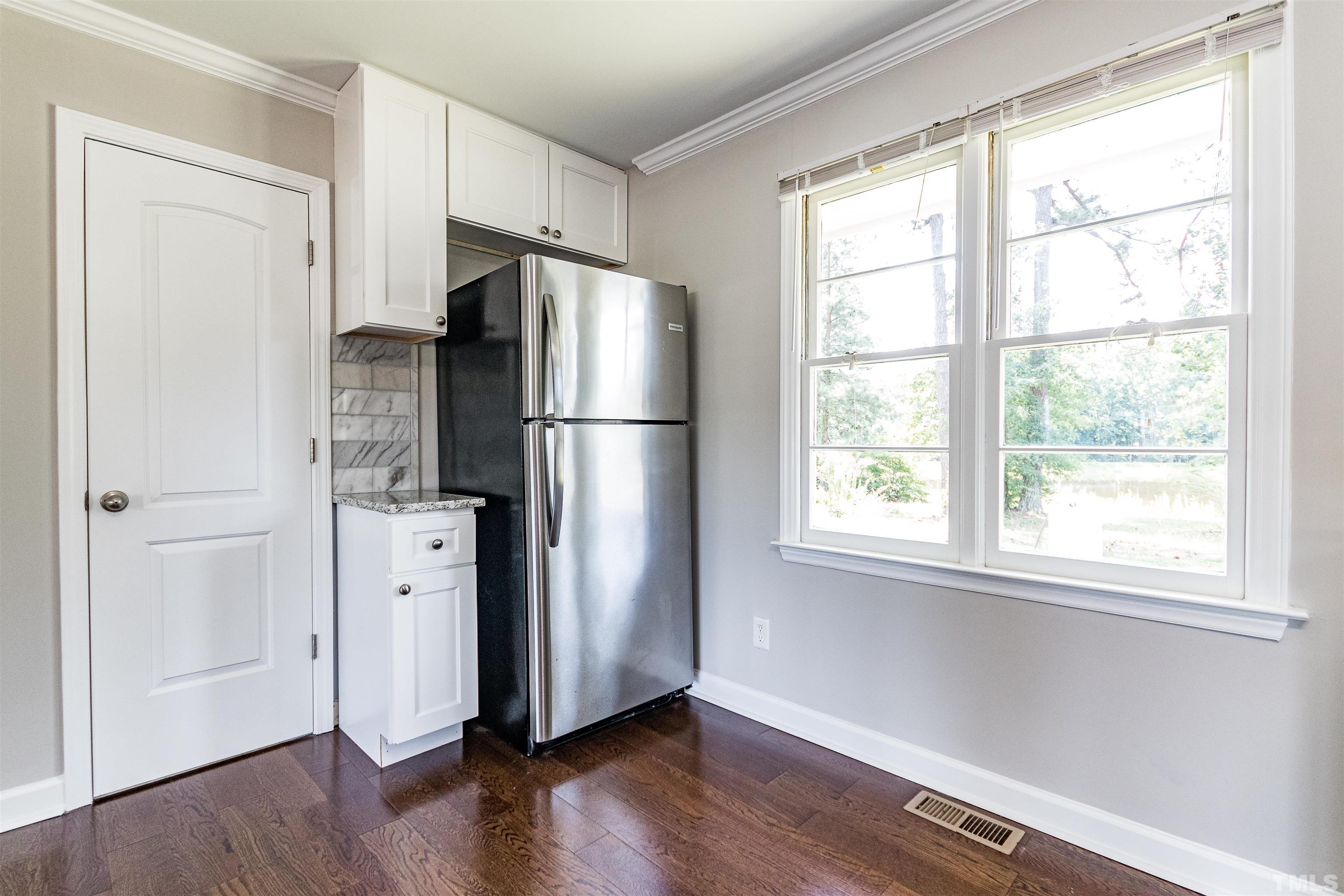 619 Pilot-Riley Road Zebulon, NC 27597 - Photo 18 of 37 a room with stainless steel appliances a refrigerator and a window