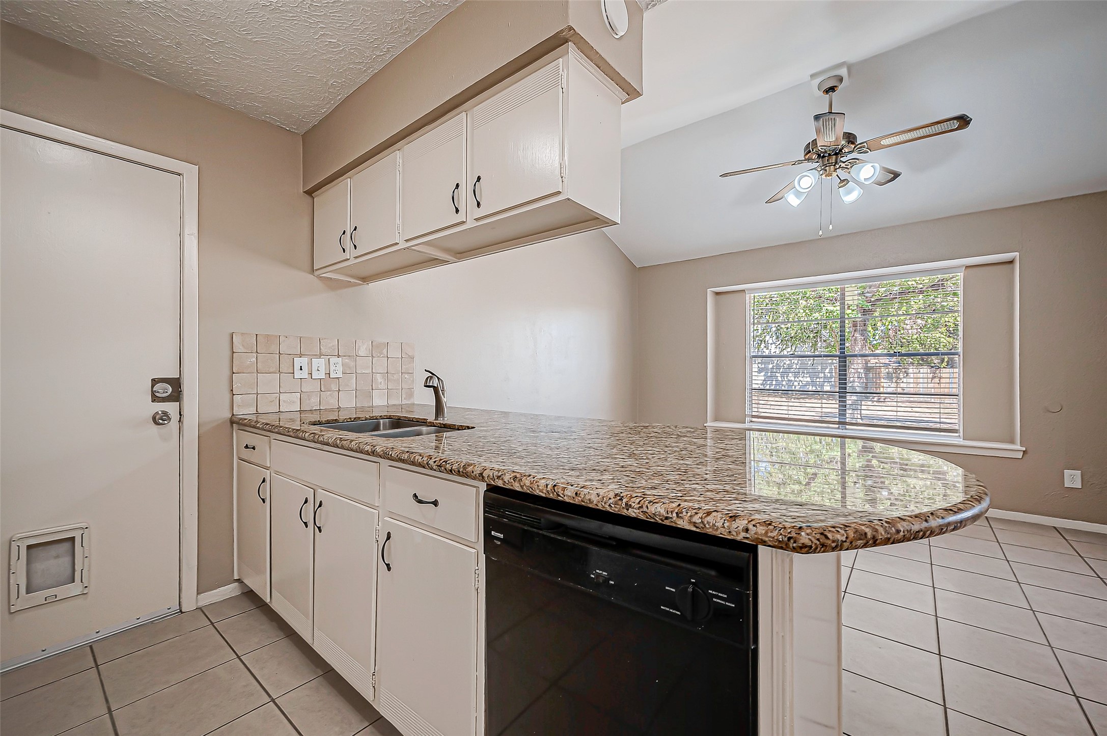 7027 Inkberry Drive Houston, TX 77092 - Photo 13 of 37 a kitchen with stainless steel appliances granite countertop a sink stove and cabinets