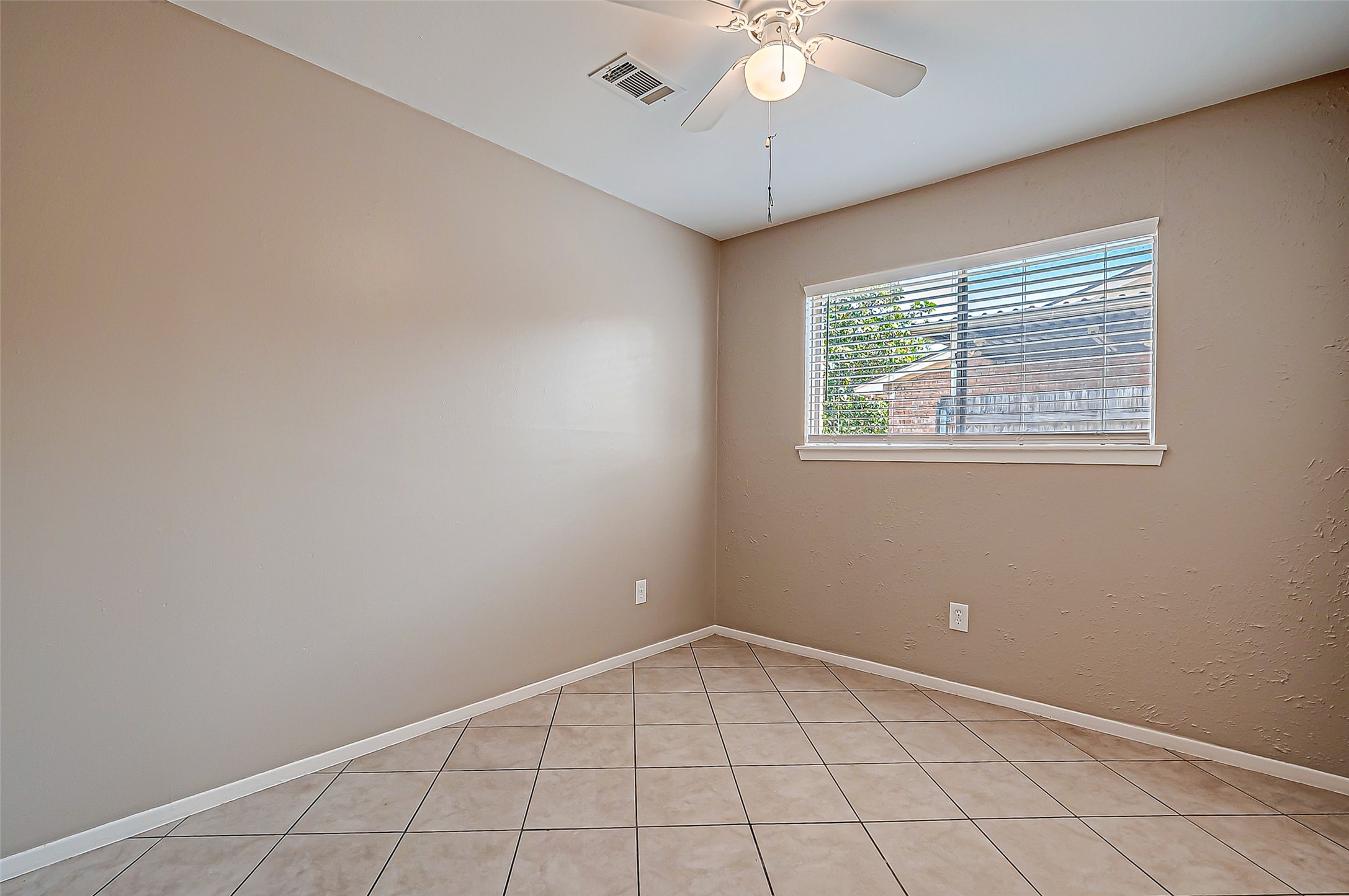 7027 Inkberry Drive Houston, TX 77092 - Photo 18 of 37 an empty room with windows