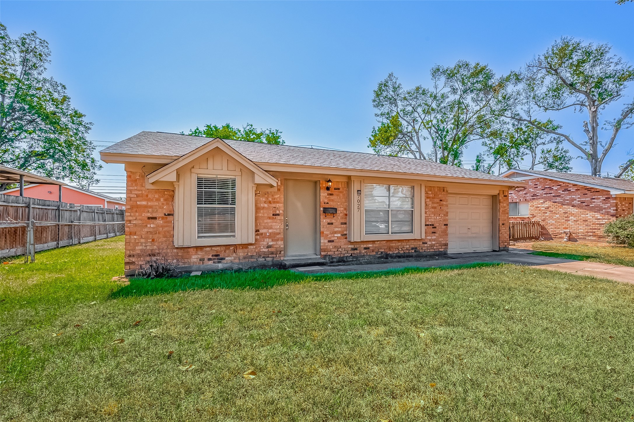 7027 Inkberry Drive Houston, TX 77092 - Photo 2 of 37 a front view of a house with a garden