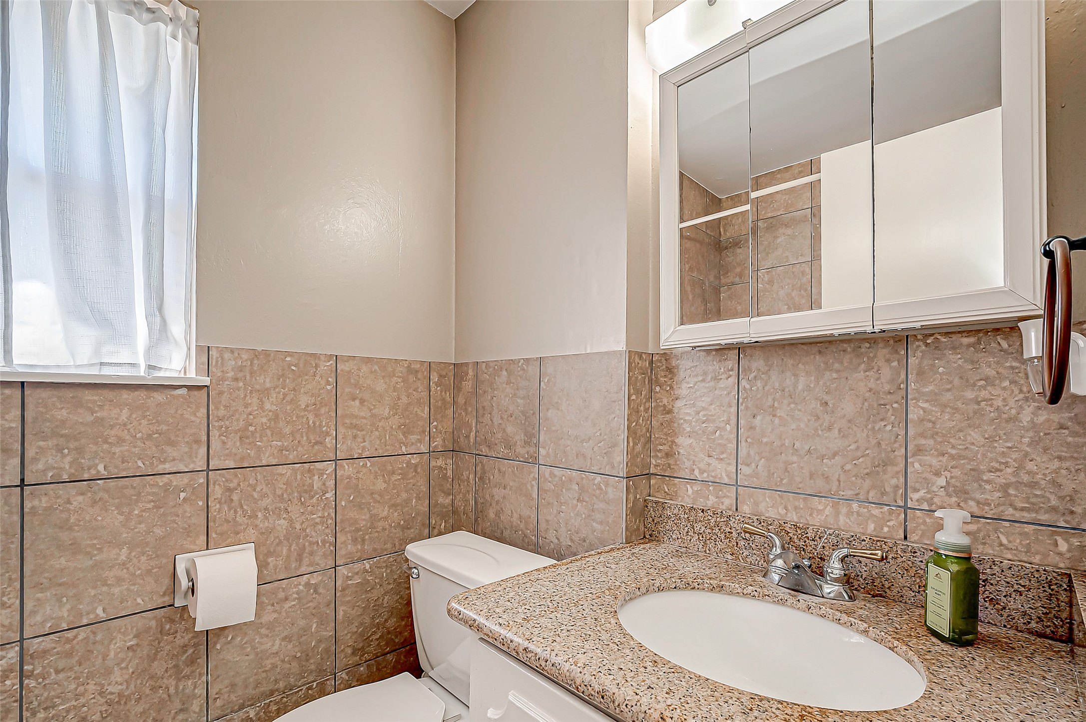 7027 Inkberry Drive Houston, TX 77092 - Photo 22 of 37 a bathroom with a sink and a mirror