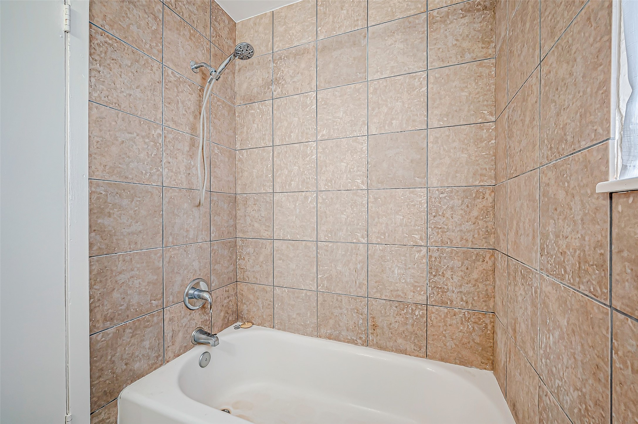 7027 Inkberry Drive Houston, TX 77092 - Photo 23 of 37 a bathroom with a white bath tub and a shower