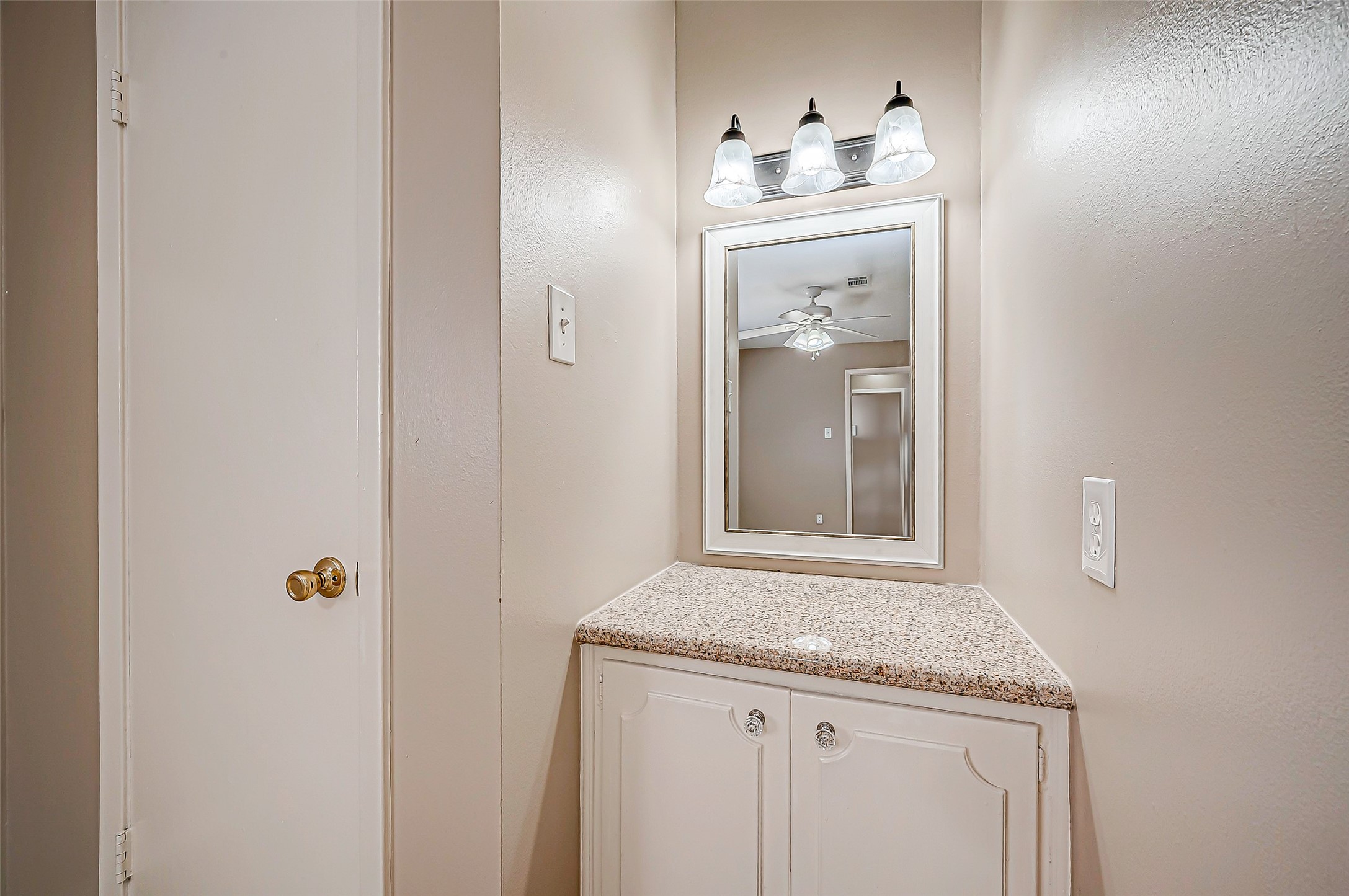 7027 Inkberry Drive Houston, TX 77092 - Photo 27 of 37 a bathroom with a granite countertop sink and a mirror