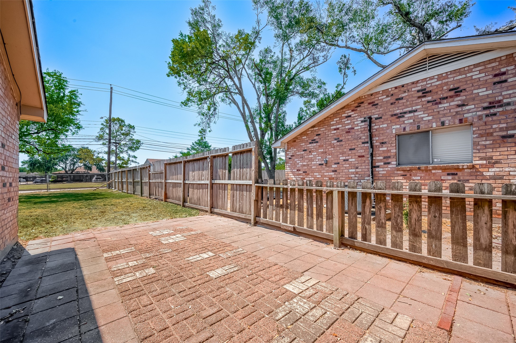 7027 Inkberry Drive Houston, TX 77092 - Photo 30 of 37 a view of backyard with wooden fence and large trees