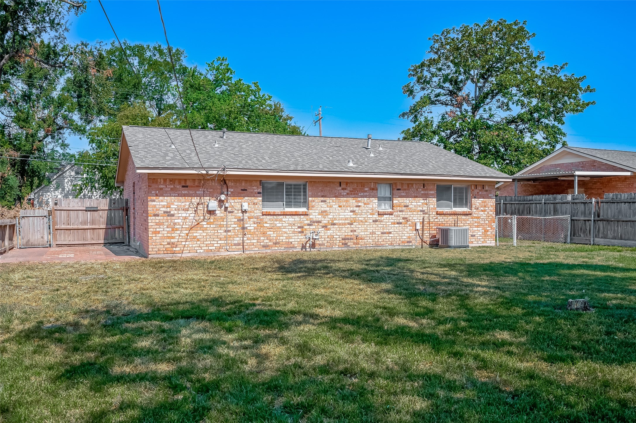 7027 Inkberry Drive Houston, TX 77092 - Photo 36 of 37 a view of a house with a yard and a tree