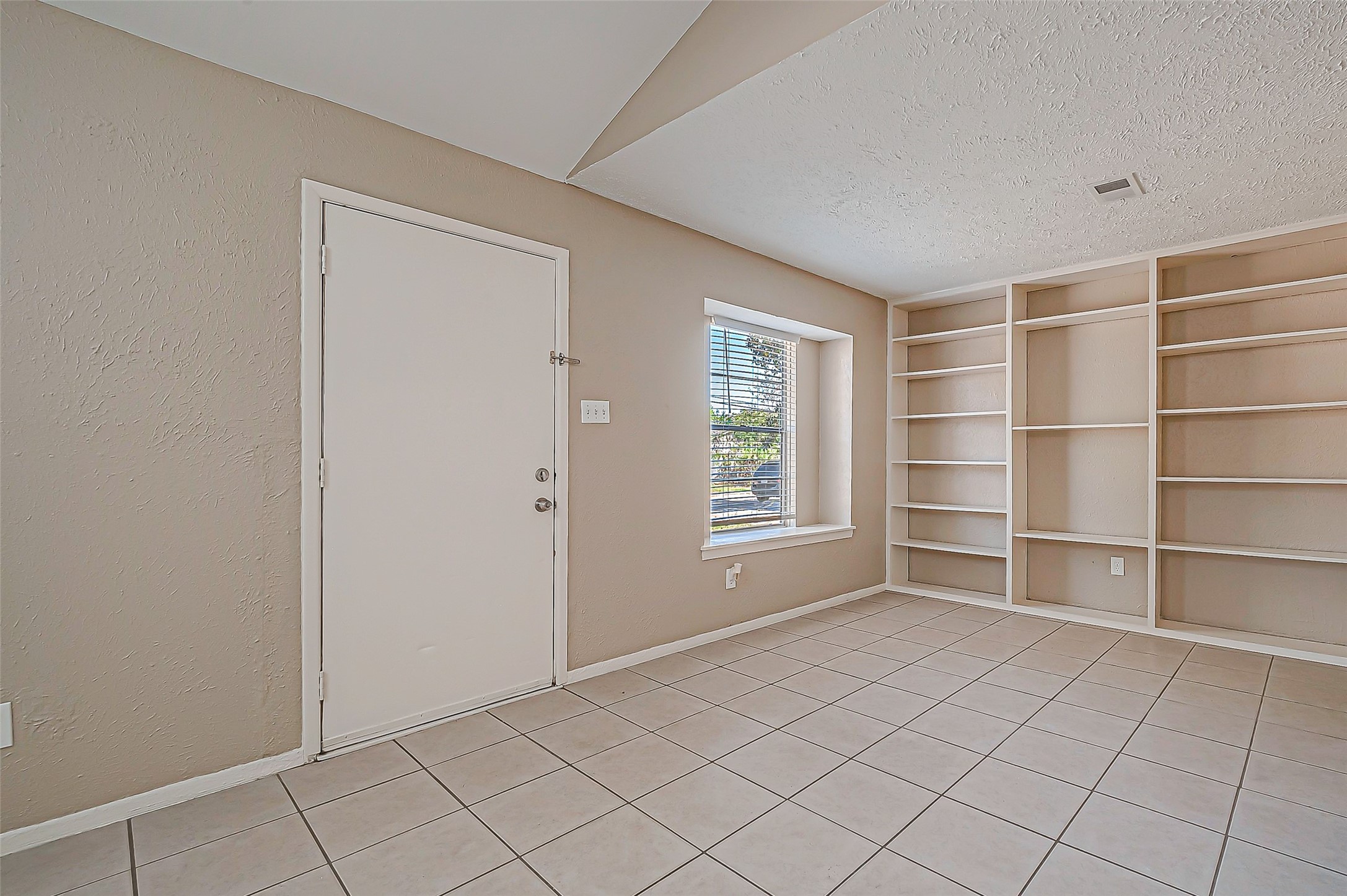 7027 Inkberry Drive Houston, TX 77092 - Photo 5 of 37 a view of an empty room with a window