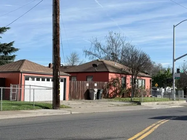 a man walking down a street next to a building