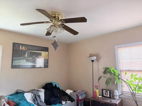 a bedroom with a bed chair and the dresser