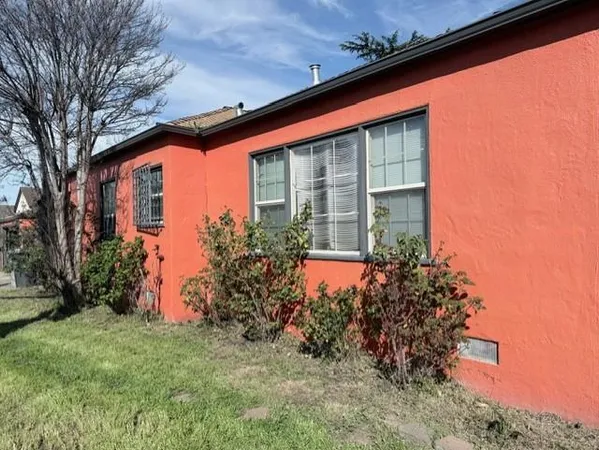 a front view of house with a garden