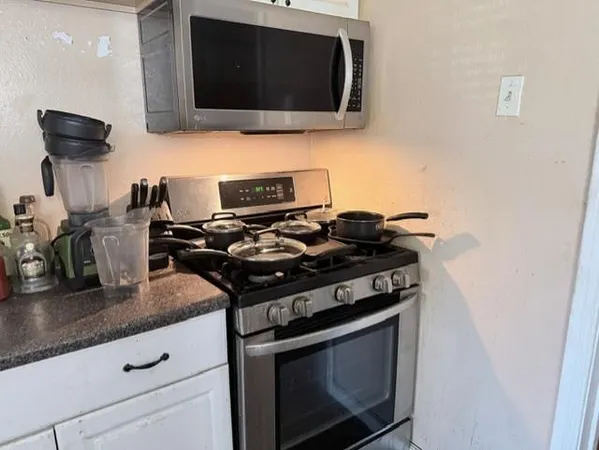 a kitchen with a stove and a microwave
