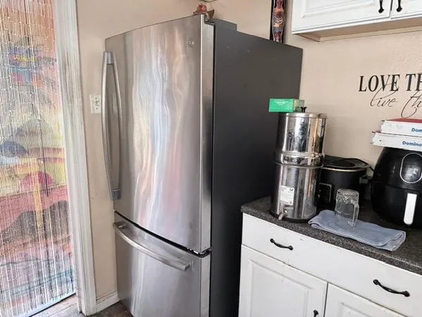 a kitchen with a refrigerator and cabinets