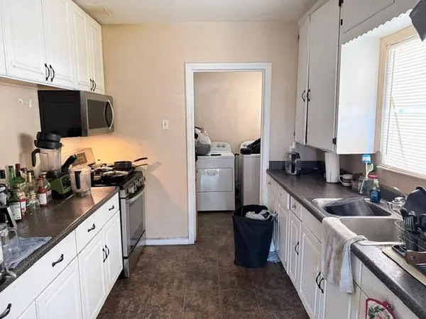 a kitchen with a sink stove and refrigerator