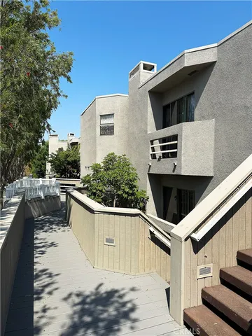 a view of a big room with wooden floor and windows