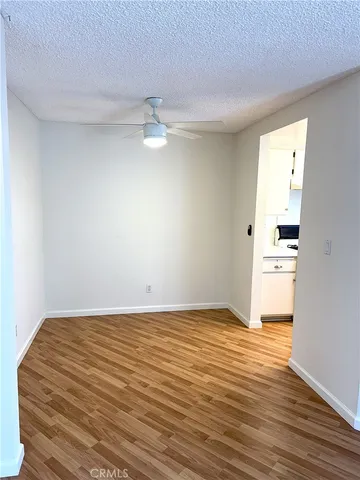 a view of a room with wooden floor
