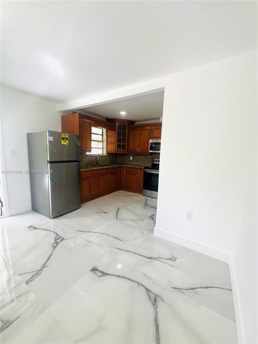 15530 Southwest 295th Terrace Homestead, FL 33033 - Photo 3 of 14 a kitchen with a refrigerator and a sink