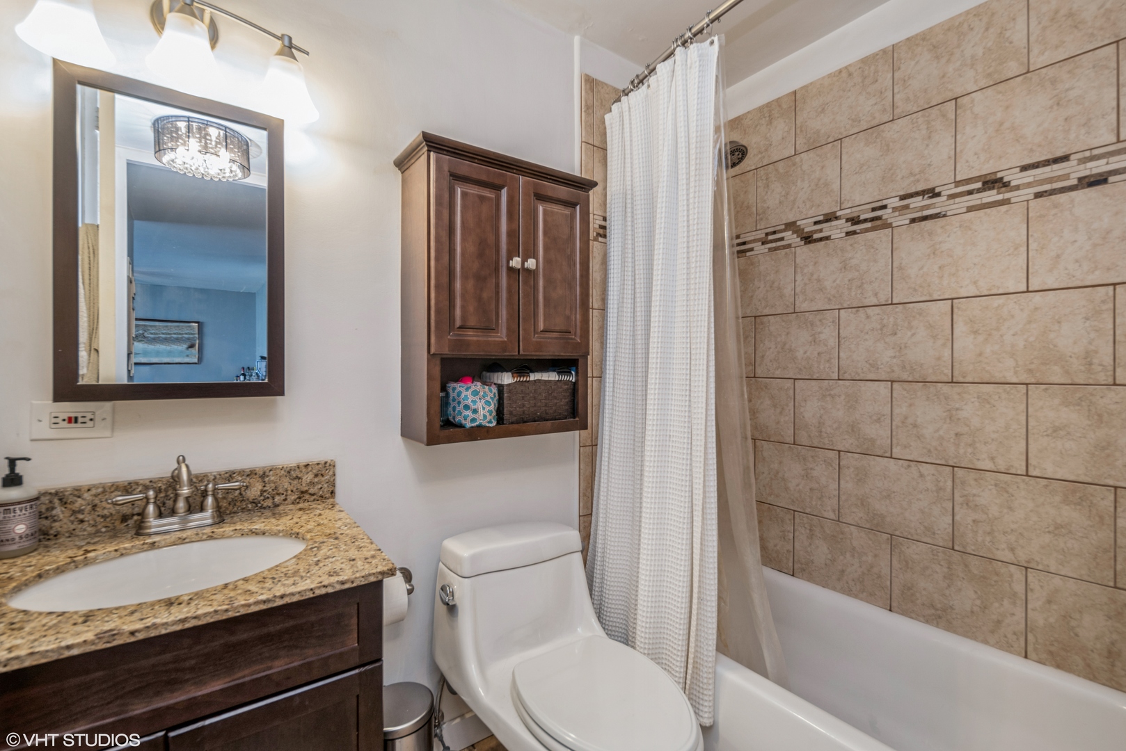 720 West Gordon Terrace, Unit 11F Chicago, IL 60613 - Photo 7 of 12 a bathroom with a granite countertop sink toilet and shower