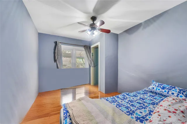 a bedroom with bed and a window