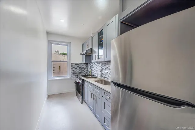 a kitchen with a stove and a refrigerator