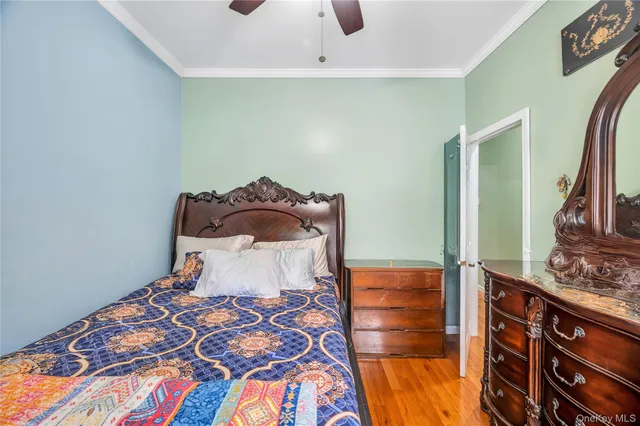 a bedroom with a bed and a lamp on the dresser