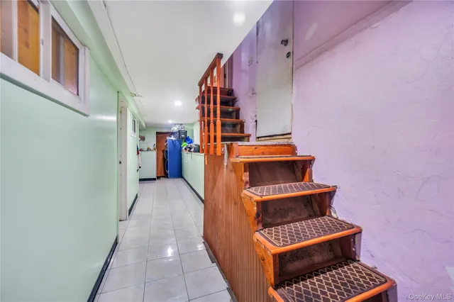 a view of stairs and hall with wooden floor