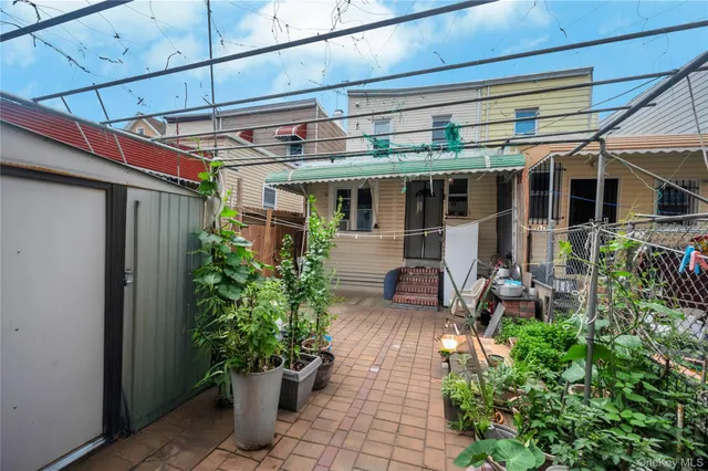 a view of a porch with chairs and potted plants