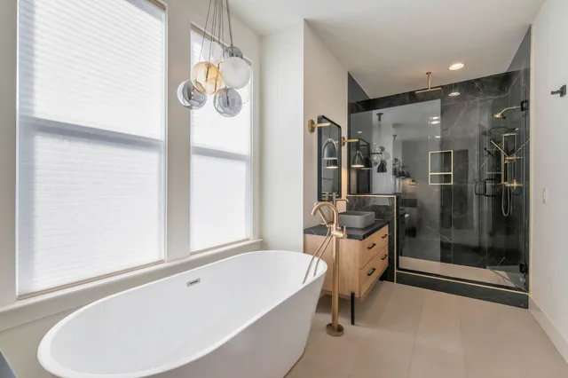 a bathroom with a tub and a view of bathroom