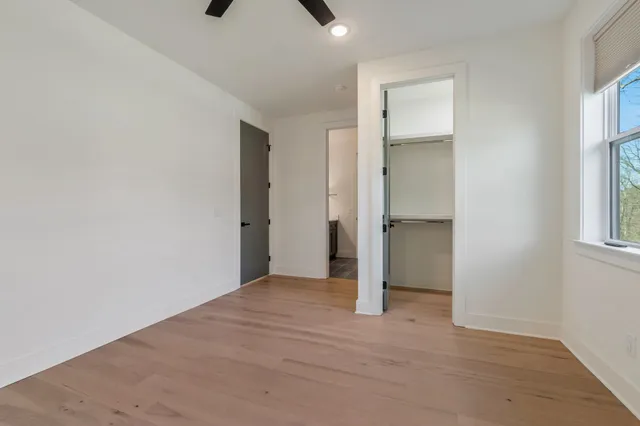 an empty room with windows and closet