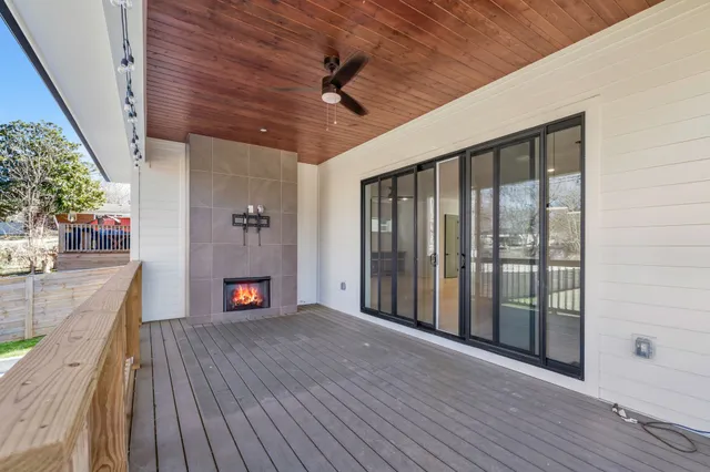 a view of an empty room with wooden floor a glass door and a glass door