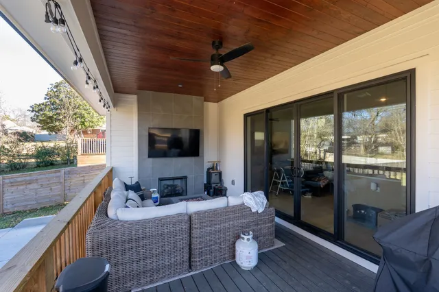 a living room with couch tv and a large window
