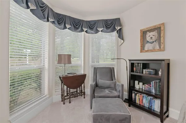 a living room with furniture and a book shelf