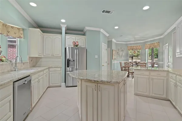 a kitchen with sink cabinets and refrigerator