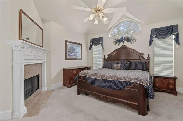 a bedroom with a bed and a fireplace