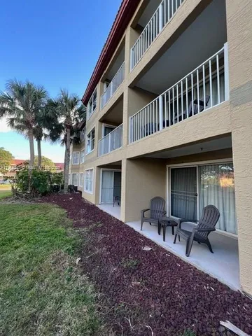 a view of a house with backyard porch and sitting area