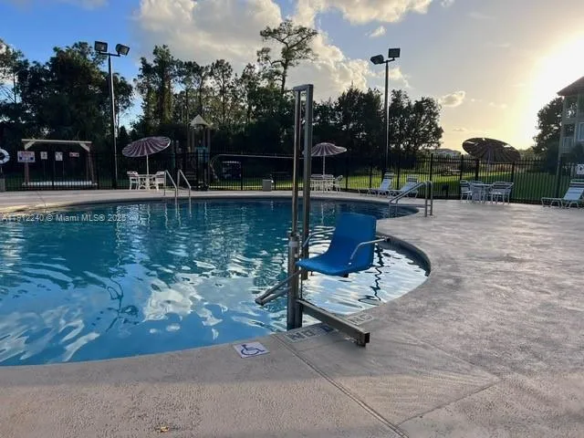 a view of a lake with a bench in the patio