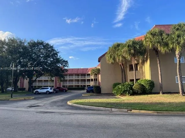 a view of street with houses and trees in the background