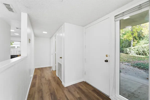 a view of hallway with wooden floor